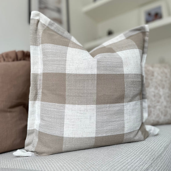 Square flanged edge cushions with large cream and brown square checked pattern