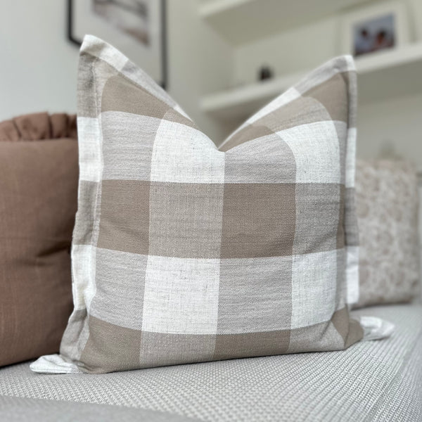 flanged edge square cushion with large cream and brown square check pattern.