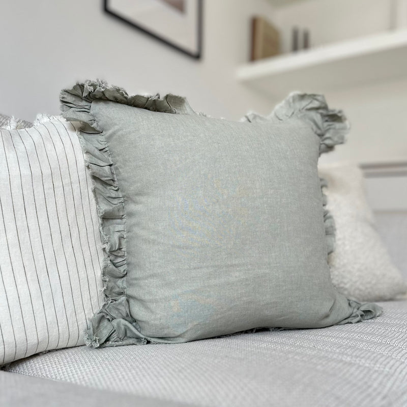 Ruffled edge sage green linen square cushion.