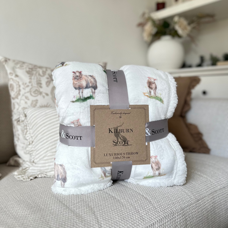 White soft and fluffy sherpa blanket with an all over white sheep print