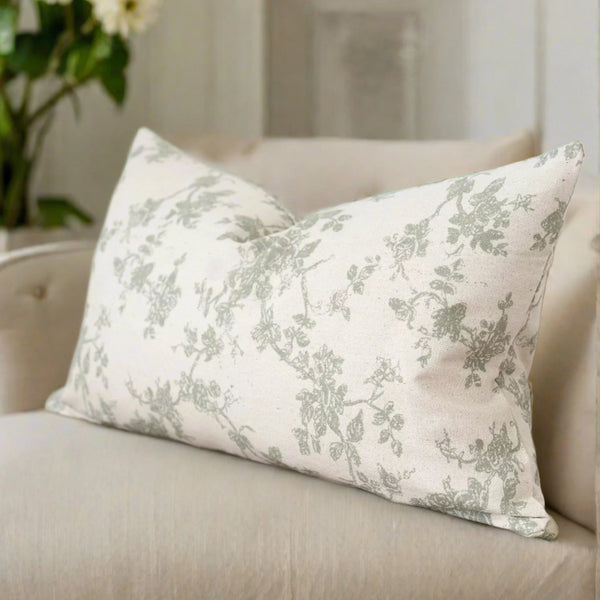 rectangle cream cushion with a soft sage green floral pattern