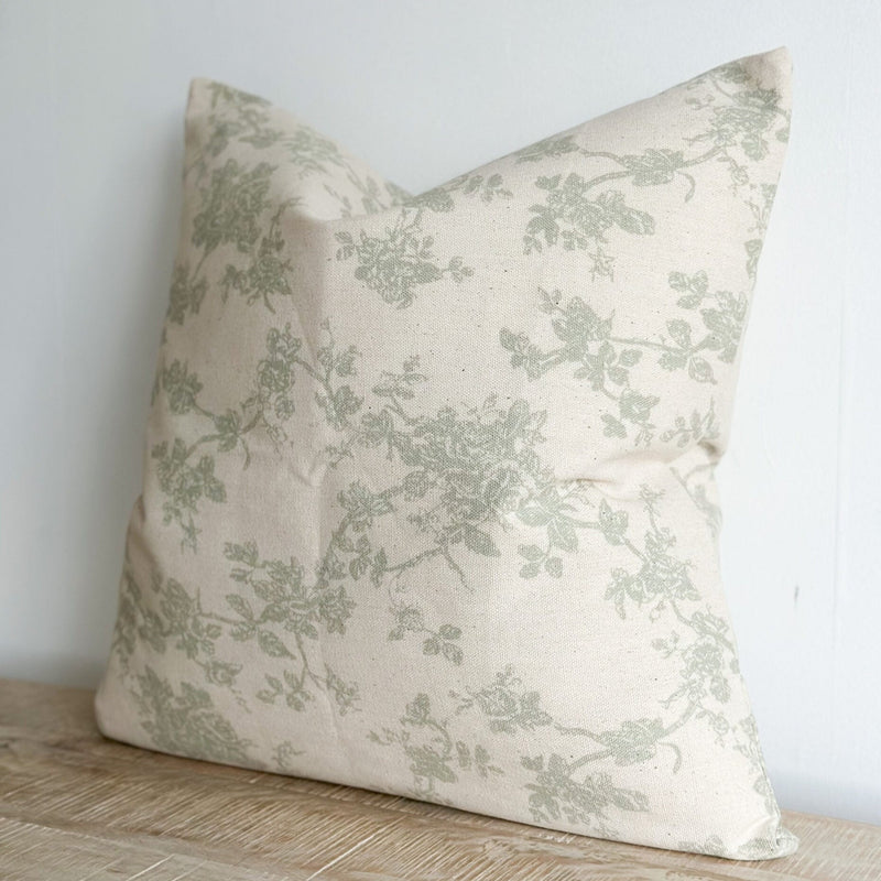 cream cotton square cushion with a delicate sage green floral print