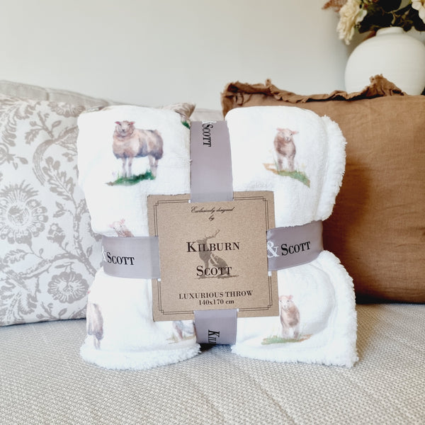 White sherpa blanket with an all over white sheep print