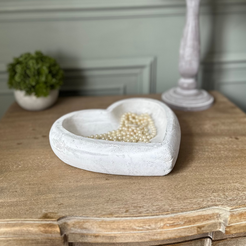 Deep Stone White Heart Dish with pearl beads stored inside. Sat on a wooden bedside table