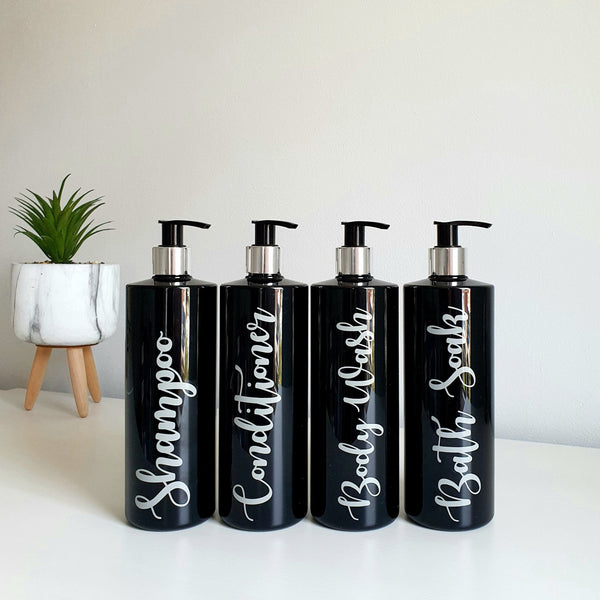 Four 500ml black reusable dispenser pump bottles with labels with Conditioner, Shampoo, Body Wash and Bath Soaks