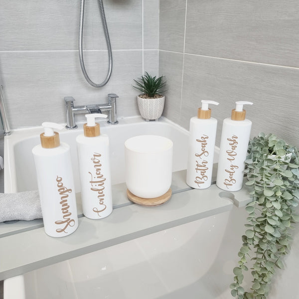 Four 500ml white dispenser bottle with bamboo lid and  customisable beige wording for shampoo conditioner body wash and bath soak in bathroom
