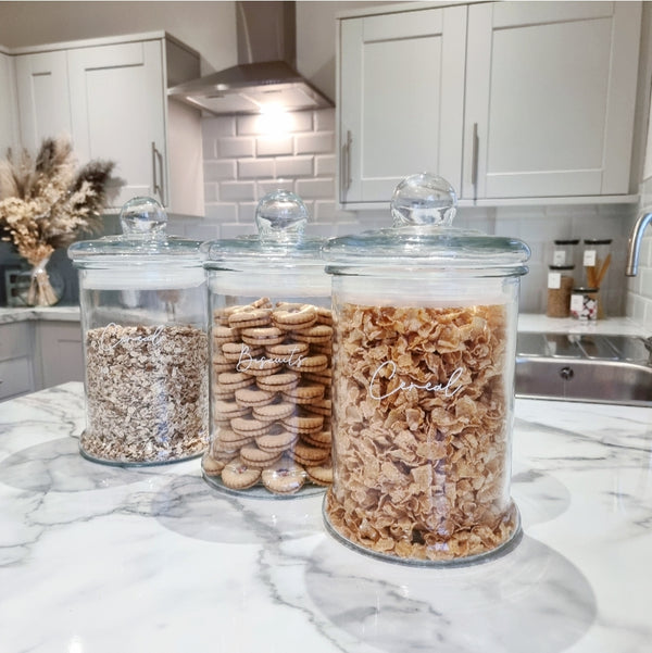 5 Litre Apothecary Glass glass  Labelled .Jar Filled with cereal with a white cereal label applied. Sat on a kitchen counter