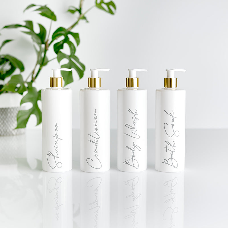 Four white and gold pump dispenser bottles with silver custom personalised wording for Shampoo, Conditioner, Body Wash and Bath Soak