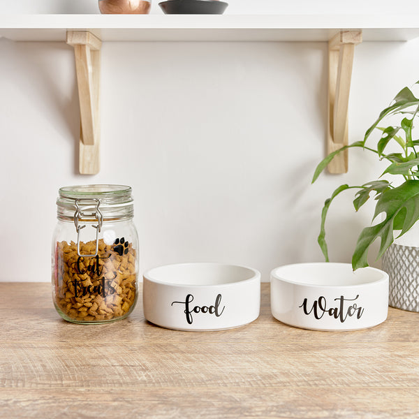 Pet bowls with personalised wording on the face for Food and Water, and a pet jar for treats with Cat Treats