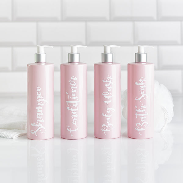 Four pink soap dispenser bottles with customisable wording for shampoo conditioner body wash and bath soak