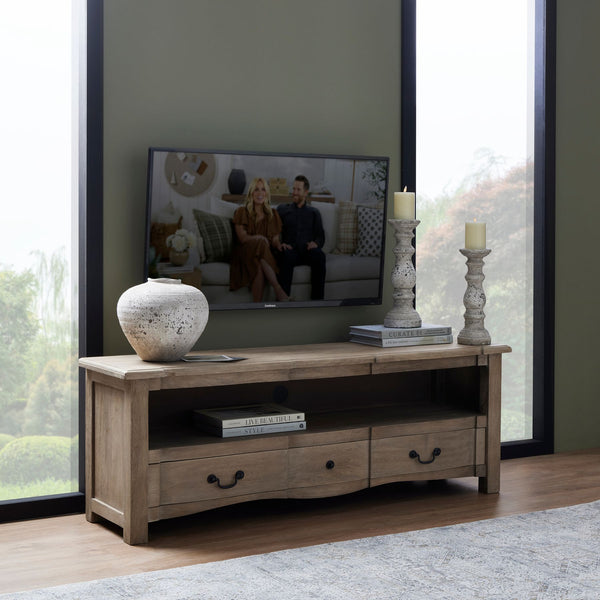 The Cotswold 1 Drawer Wooden  Media Unit sat in a living room with a vase on the top with stone candle pillars